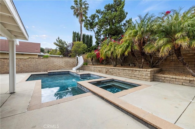21643 Spice Ct, Saugus, CA 91350 - view of swimming pool featuring a water slide, a patio area, a fenced backyard, and a pool with connected hot tub