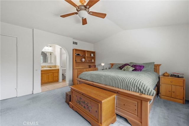 21643 Spice Ct, Saugus, CA 91350 - bedroom featuring light colored carpet, lofted ceiling, arched walkways, ensuite bathroom, and a ceiling fan