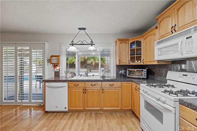 21643 Spice Ct, Saugus, CA 91350 - kitchen with white appliances, glass insert cabinets, light wood finished floors, tasteful backsplash, and pendant lighting
