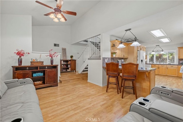 21643 Spice Ct, Saugus, CA 91350 - living area with a ceiling fan, light wood-style floors, stairway, and vaulted ceiling