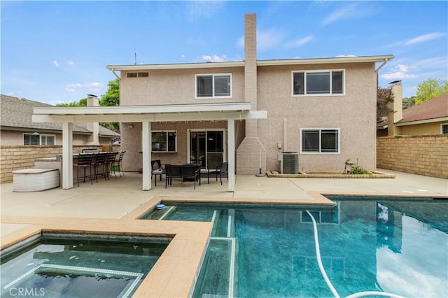 21643 Spice Ct, Saugus, CA 91350 - rear view of property featuring stucco siding, an in-ground hot tub, and a patio area
