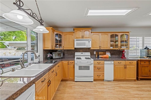 21643 Spice Ct, Saugus, CA 91350 - kitchen with white appliances, hanging light fixtures, glass insert cabinets, light wood-style floors, and decorative backsplash