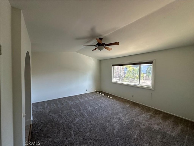 21643 Spice Ct, Saugus, CA 91350 - empty room featuring dark carpet, lofted ceiling, a ceiling fan, and arched walkways