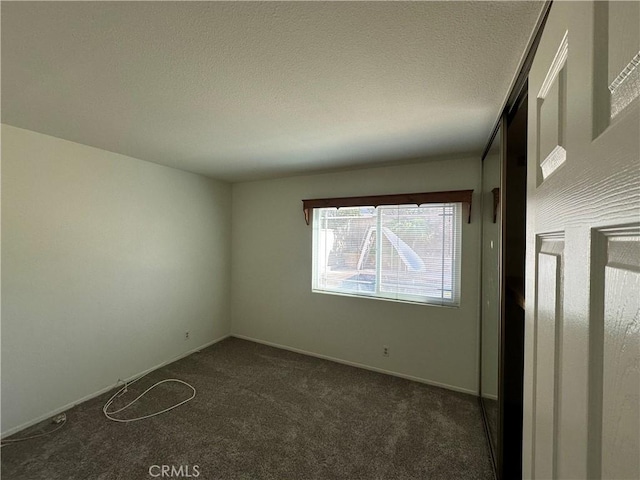 21643 Spice Ct, Saugus, CA 91350 - empty room with dark carpet and a textured ceiling