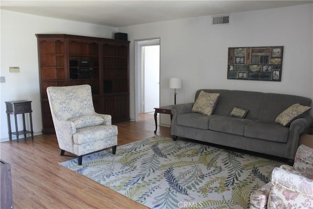 living room featuring wood finished floors and visible vents
