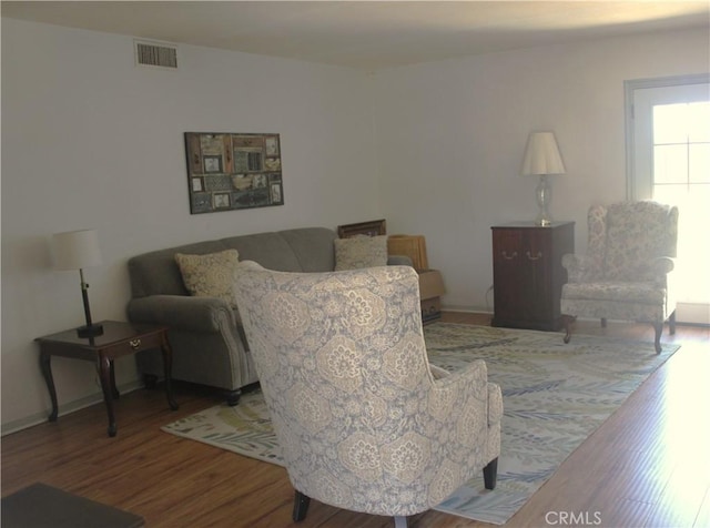 living room featuring wood finished floors and visible vents