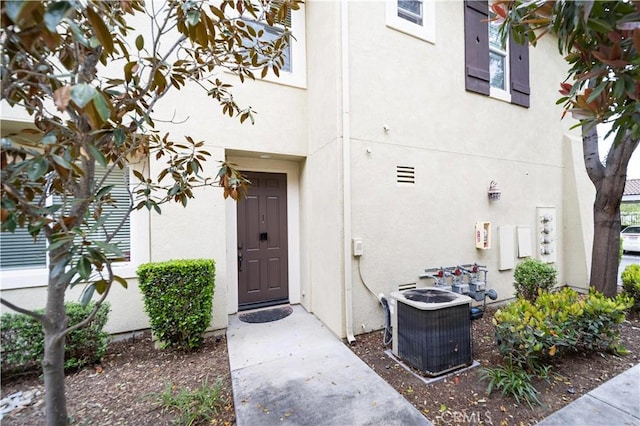 27518 Hazelhurst St Unit 1, Murrieta, CA 92562 - doorway to property with stucco siding and central air condition unit