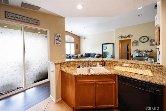 27518 Hazelhurst St Unit 1, Murrieta, CA 92562 - kitchen with black dishwasher, light stone counters, a ceiling fan, open floor plan, and brown cabinetry