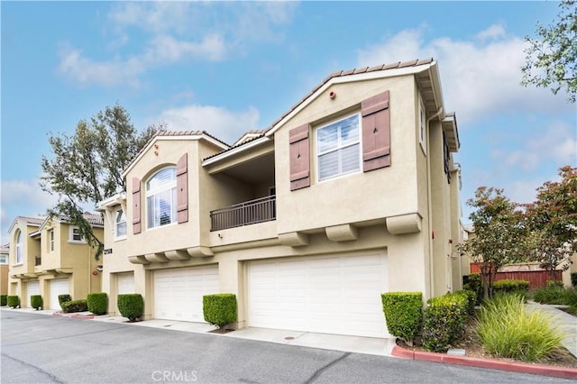 27518 Hazelhurst St Unit 1, Murrieta, CA 92562 - multi unit property with stucco siding, a balcony, an attached garage, and a tile roof