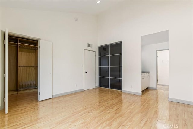 4730 Ben Ave Unit 3, Valley Village, CA 91607 - unfurnished bedroom with visible vents, light wood finished floors, baseboards, and a high ceiling