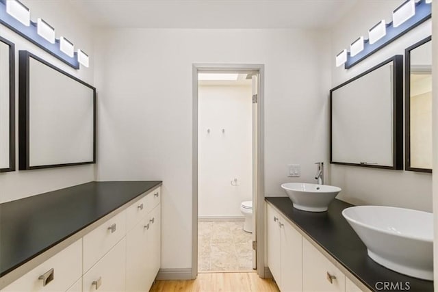 4730 Ben Ave Unit 3, Valley Village, CA 91607 - full bathroom featuring toilet, wood finished floors, a sink, and double vanity
