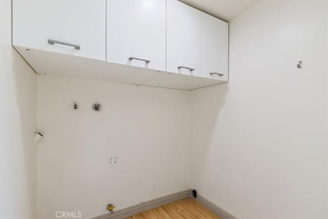 4730 Ben Ave Unit 3, Valley Village, CA 91607 - washroom featuring baseboards, light wood-style floors, and cabinet space
