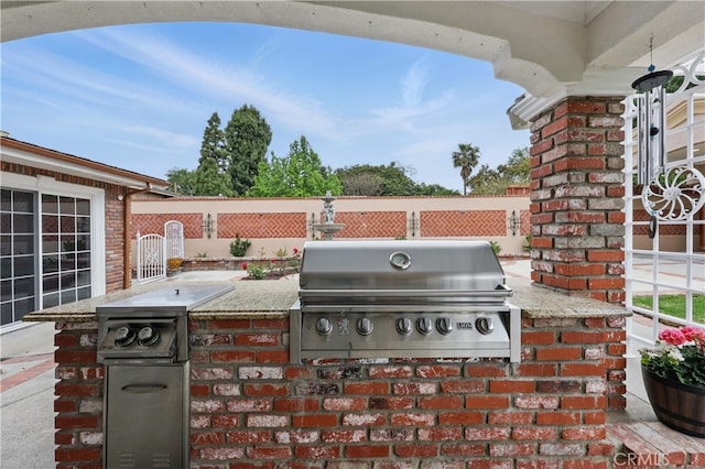view of patio featuring grilling area, fence, and area for grilling
