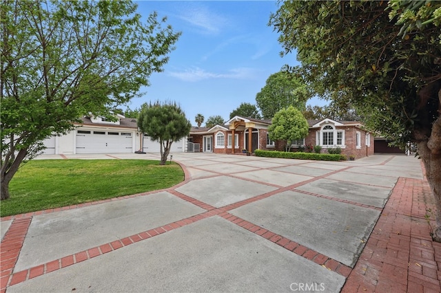ranch-style house featuring a garage, driveway, and a front lawn