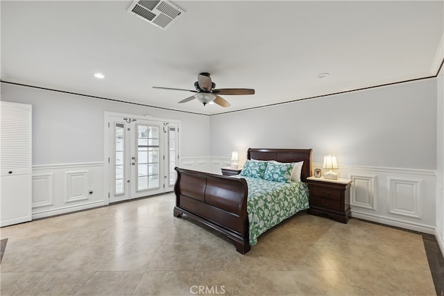 bedroom featuring access to exterior, wainscoting, visible vents, a ceiling fan, and a decorative wall