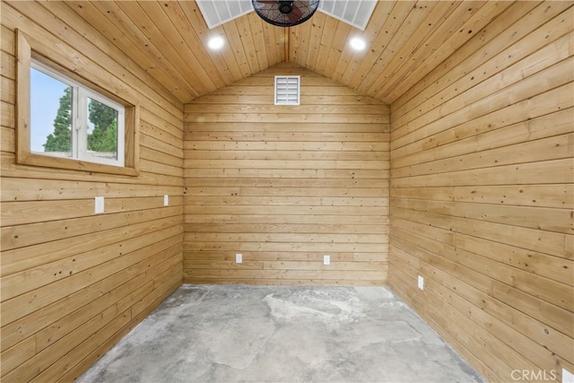unfurnished room featuring recessed lighting, wooden walls, lofted ceiling, and concrete floors