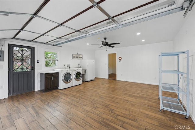 laundry area featuring washing machine and dryer, wood finished floors, recessed lighting, and cabinet space