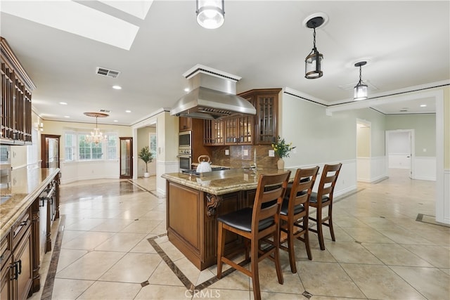 kitchen with light tile patterned flooring, visible vents, light stone counters, crown molding, and appliances with stainless steel finishes