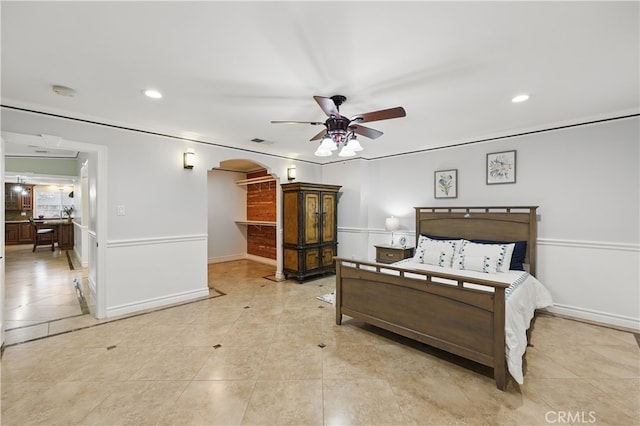 bedroom featuring baseboards, visible vents, arched walkways, and light tile patterned floors