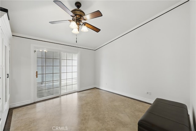 empty room with baseboards, a ceiling fan, and crown molding
