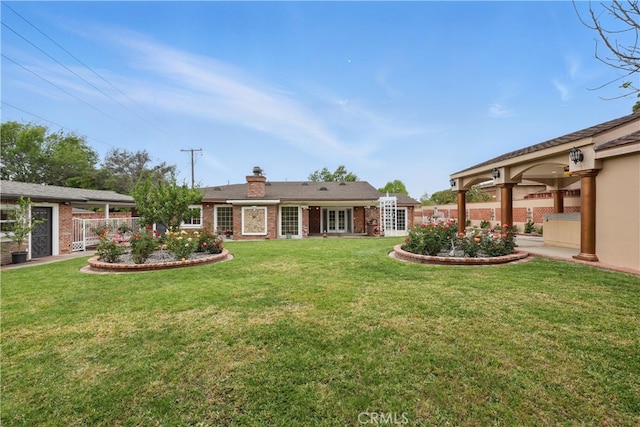 view of yard with fence and french doors