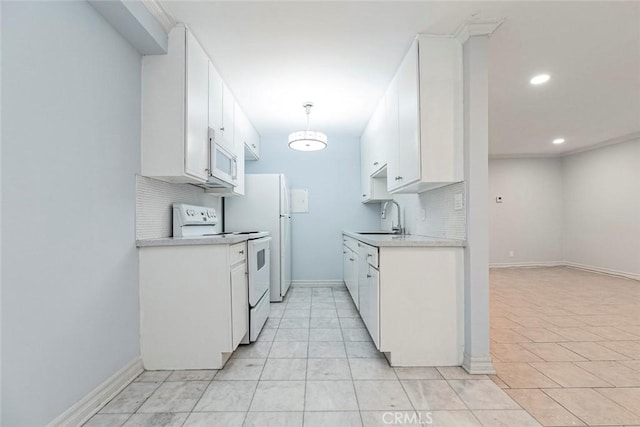 121 Sinclair Ave Unit 122, Glendale, CA 91206 - kitchen featuring white cabinets, backsplash, light countertops, a sink, and white appliances
