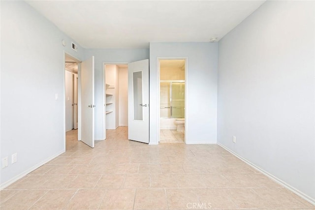 121 Sinclair Ave Unit 122, Glendale, CA 91206 - unfurnished bedroom with baseboards, a closet, a walk in closet, ensuite bath, and light tile patterned floors