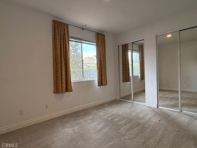 855 Wilcox Ave Unit 103, Los Angeles, CA 90038 - unfurnished bedroom featuring multiple closets and carpet flooring
