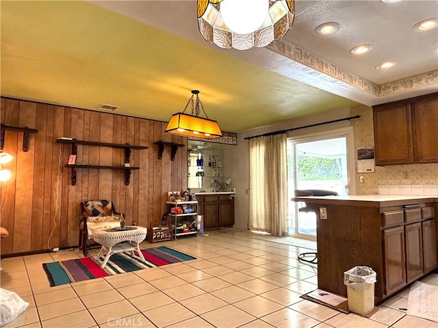 1193 W Molly Ct, Upland, CA 91786 - kitchen featuring light countertops, wooden walls, visible vents, and light tile patterned floors