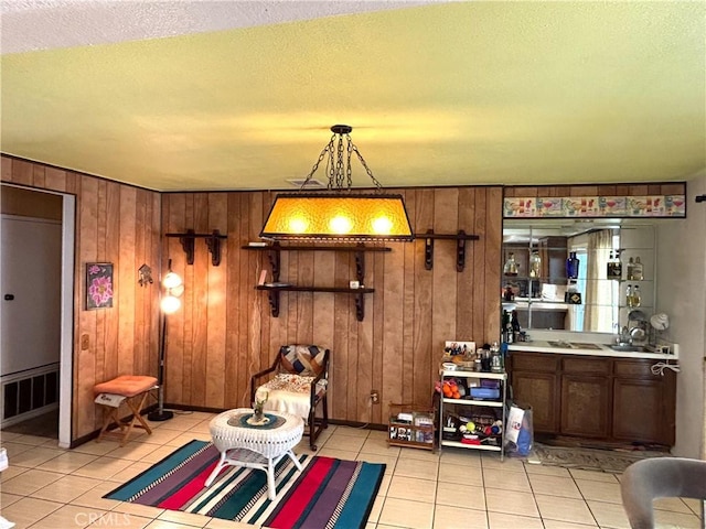 1193 W Molly Ct, Upland, CA 91786 - sitting room with wooden walls, visible vents, a textured ceiling, and light tile patterned floors