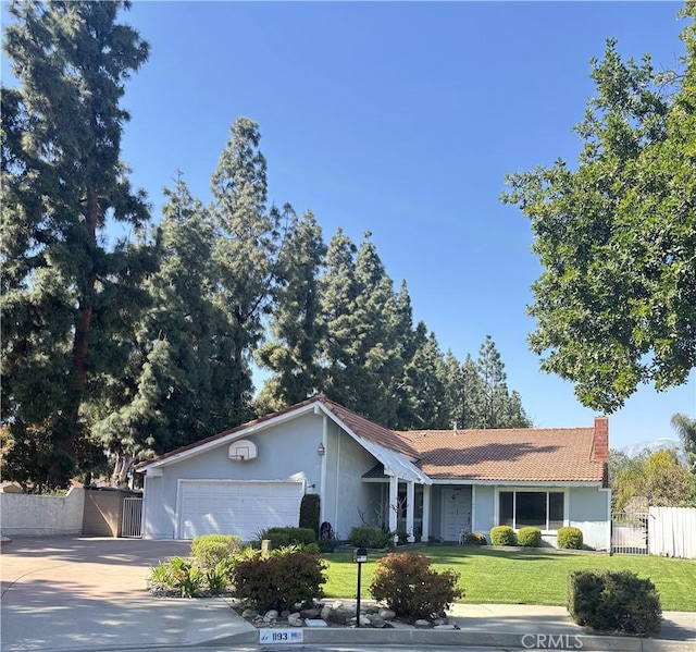 1193 W Molly Ct, Upland, CA 91786 - ranch-style home with a tiled roof, a gate, driveway, an attached garage, and a front yard