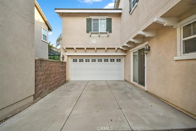 15785 Approach Ave, Chino, CA 91708 - exterior space featuring a garage, stucco siding, concrete driveway, and fence