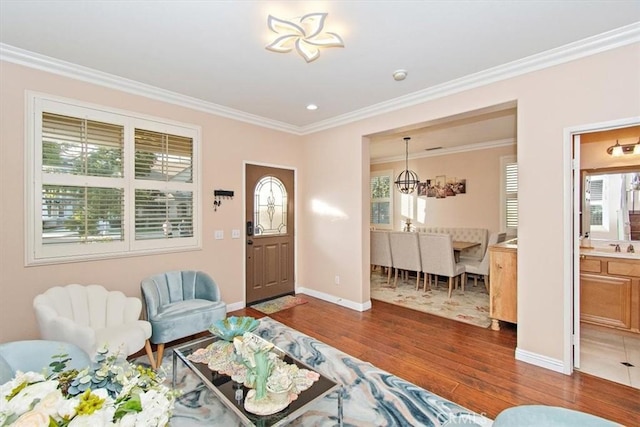 15785 Approach Ave, Chino, CA 91708 - living area featuring dark wood finished floors, ornamental molding, healthy amount of natural light, and a chandelier