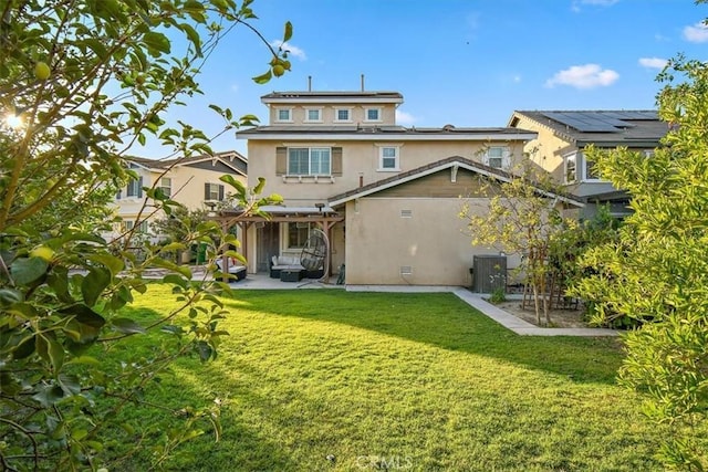 15785 Approach Ave, Chino, CA 91708 - rear view of house with a pergola, a patio area, a lawn, roof mounted solar panels, and stucco siding