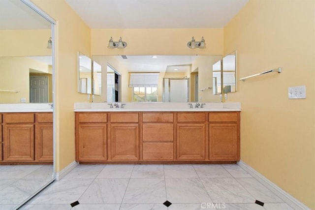 15785 Approach Ave, Chino, CA 91708 - bathroom with baseboards, vanity, marble finish floor, and a stall shower