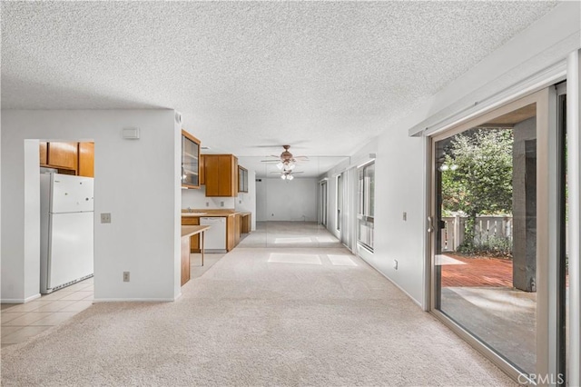 254 Sequoia Ct Unit 12, Thousand Oaks, CA 91360 - interior space with a textured ceiling, light tile patterned floors, ceiling fan, light carpet, and baseboards