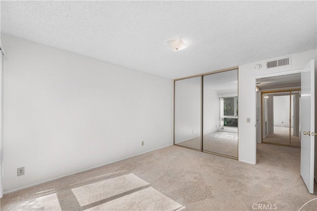 254 Sequoia Ct Unit 12, Thousand Oaks, CA 91360 - unfurnished bedroom featuring carpet floors, a textured ceiling, visible vents, and a closet