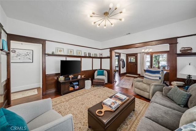 1339 Higuera St, San Luis Obispo, CA 93401 - living room featuring visible vents, baseboards, wood finished floors, and a notable chandelier