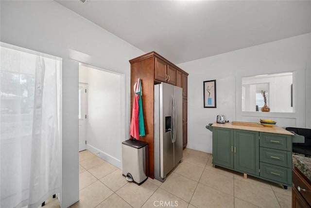 1339 Higuera St, San Luis Obispo, CA 93401 - kitchen featuring stainless steel refrigerator with ice dispenser, green cabinetry, light countertops, and light tile patterned floors