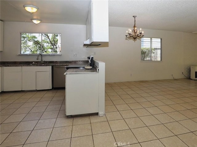 kitchen featuring plenty of natural light, white cabinetry, stainless steel appliances, and a sink