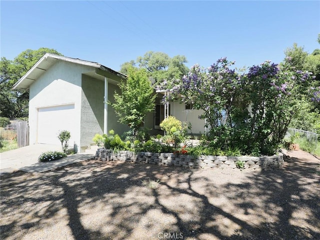 view of home's exterior featuring driveway and stucco siding