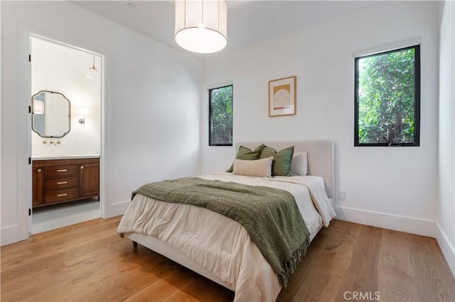 5142 Brynhurst Ave, Los Angeles, CA 90043 - bedroom featuring connected bathroom, baseboards, multiple windows, and light wood-type flooring
