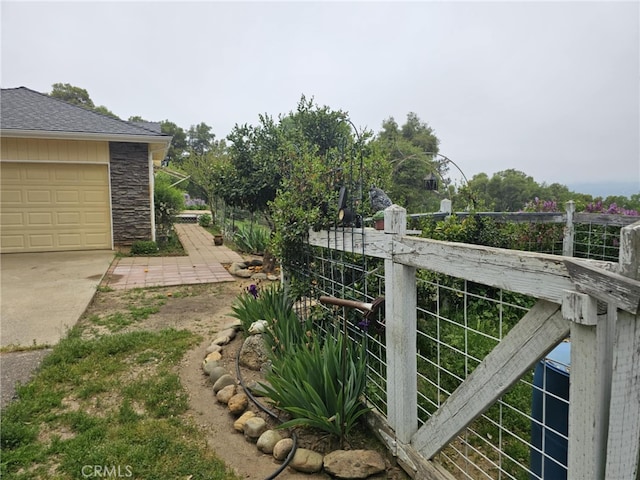 view of yard with driveway and a garage