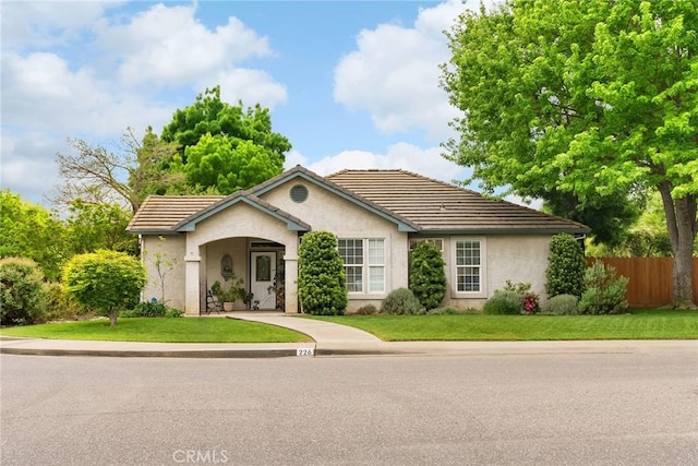226 Stony Creek Dr, Orland, CA 95963 - view of front of house featuring fence, stucco siding, a tile roof, and a front yard