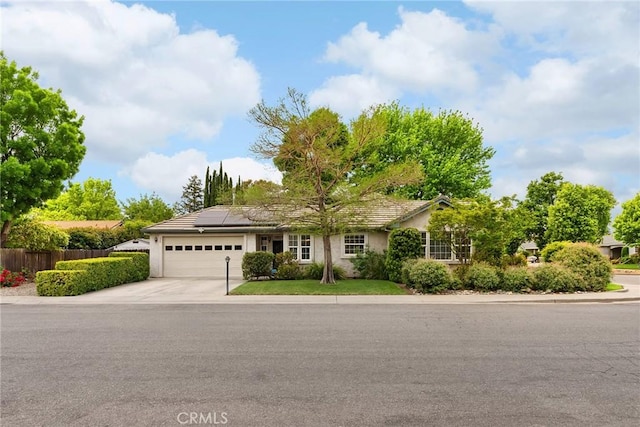 226 Stony Creek Dr, Orland, CA 95963 - single story home featuring fence, an attached garage, stucco siding, concrete driveway, and solar panels
