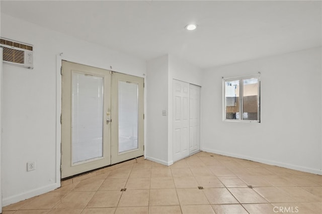 15430 Parthenia St, North Hills, CA 91343 - unfurnished bedroom featuring recessed lighting, tile patterned flooring, an AC wall unit, french doors, and baseboards