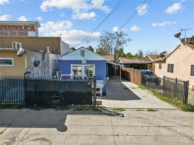 15430 Parthenia St, North Hills, CA 91343 - rear view of house with a fenced front yard and concrete driveway