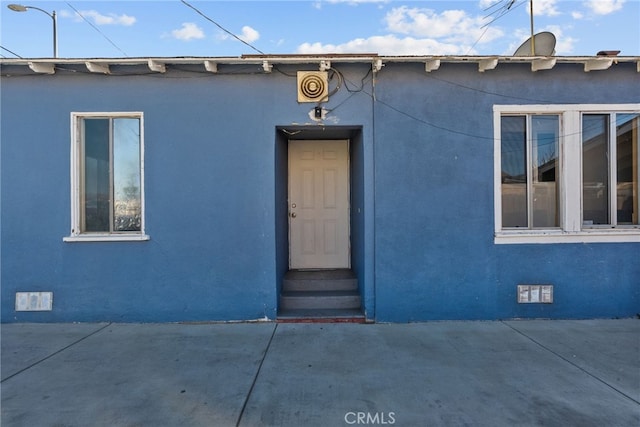 15430 Parthenia St, North Hills, CA 91343 - view of exterior entry featuring crawl space, a patio, and stucco siding