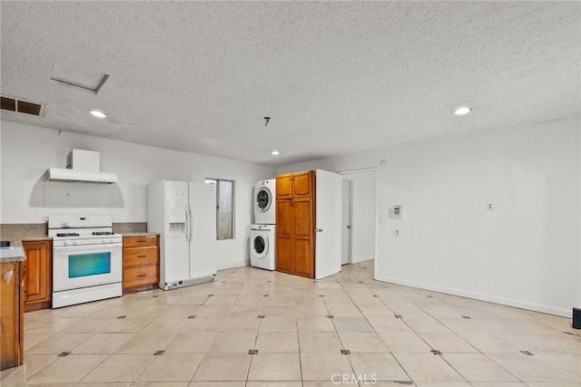 15430 Parthenia St, North Hills, CA 91343 - kitchen featuring range hood, stacked washer / dryer, visible vents, white appliances, and brown cabinetry