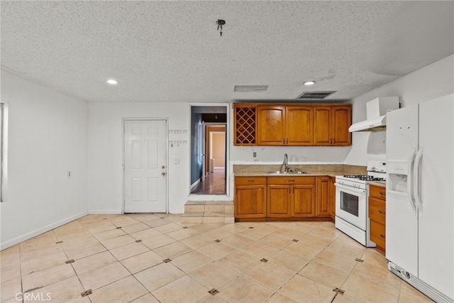 15430 Parthenia St, North Hills, CA 91343 - kitchen with brown cabinets, visible vents, a sink, white appliances, and a textured ceiling